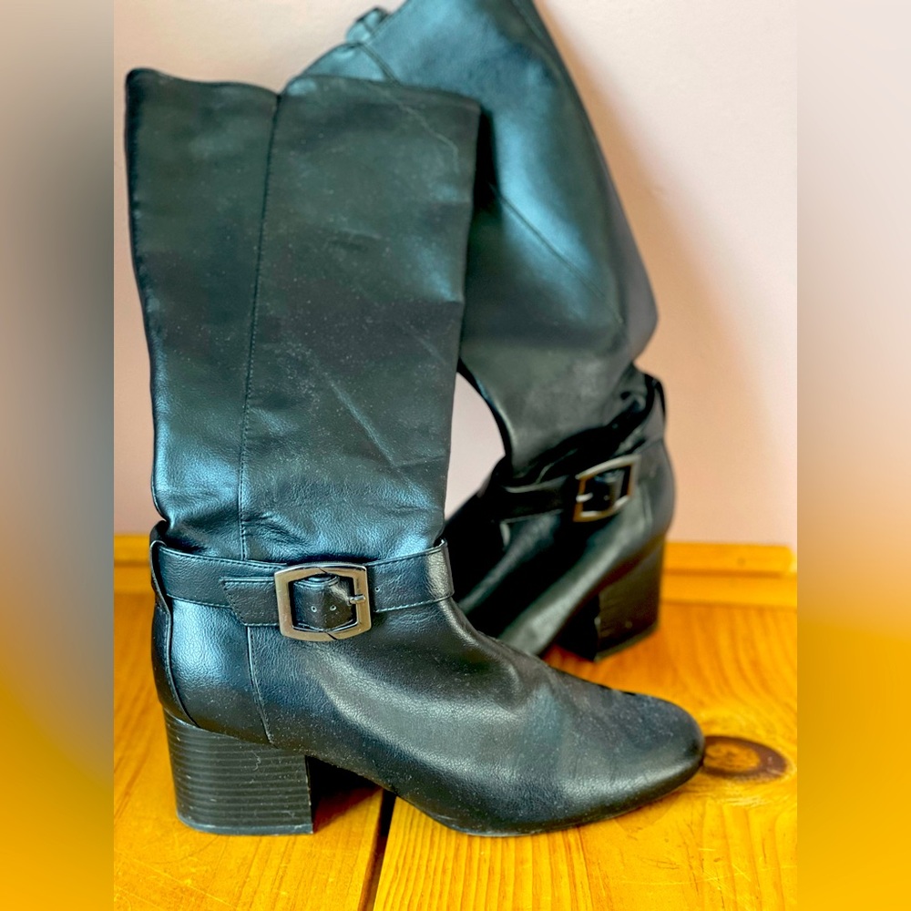 Gently worn tall, heeled boots.